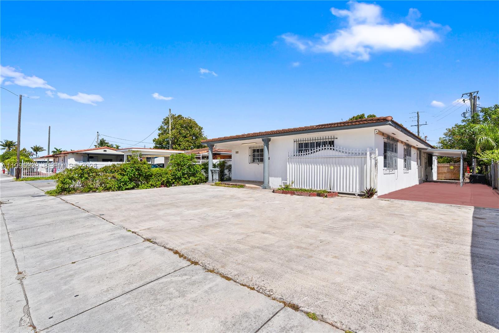 361 East 39th Street, Unit 1 Hialeah, FL 33013 - Photo 2 of 47 a front view of a house with a yard and garage