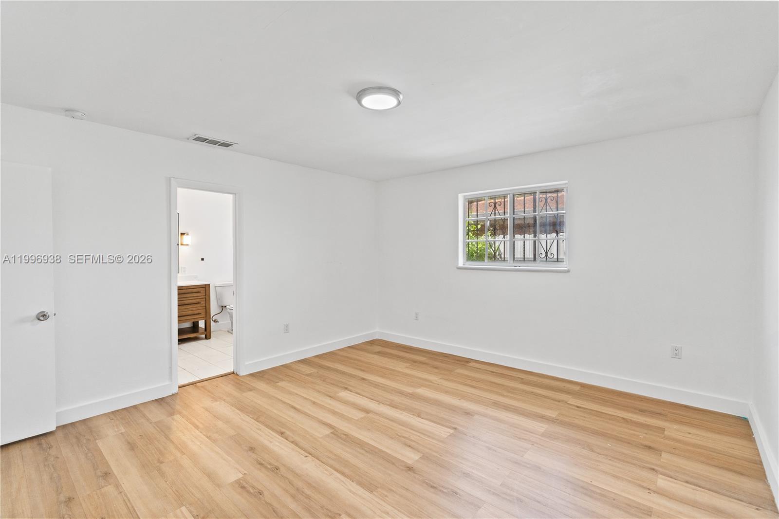 361 East 39th Street, Unit 1 Hialeah, FL 33013 - Photo 26 of 47 a view of empty room with wooden floor and fan