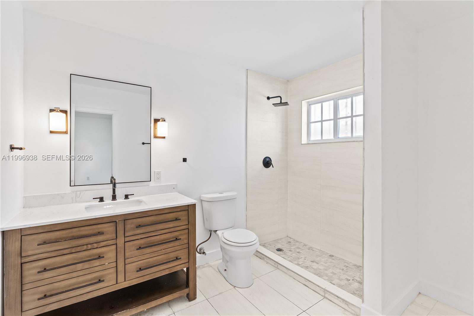 361 East 39th Street, Unit 1 Hialeah, FL 33013 - Photo 28 of 47 a bathroom with a double vanity sink toilet mirror and shower