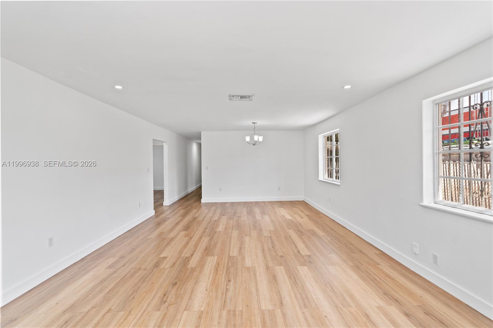 361 East 39th Street, Unit 1 Hialeah, FL 33013 - Photo 31 of 47 a view of empty room with wooden floor and fan