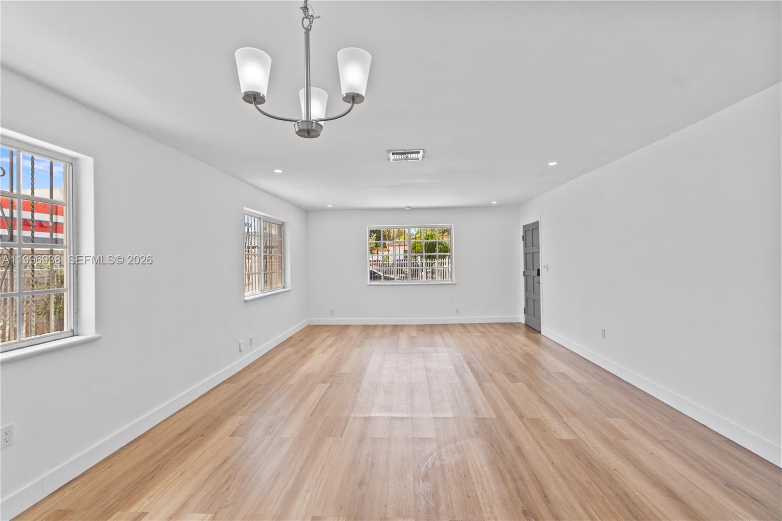 361 East 39th Street, Unit 1 Hialeah, FL 33013 - Photo 32 of 47 a view of an empty room with wooden floor and a window