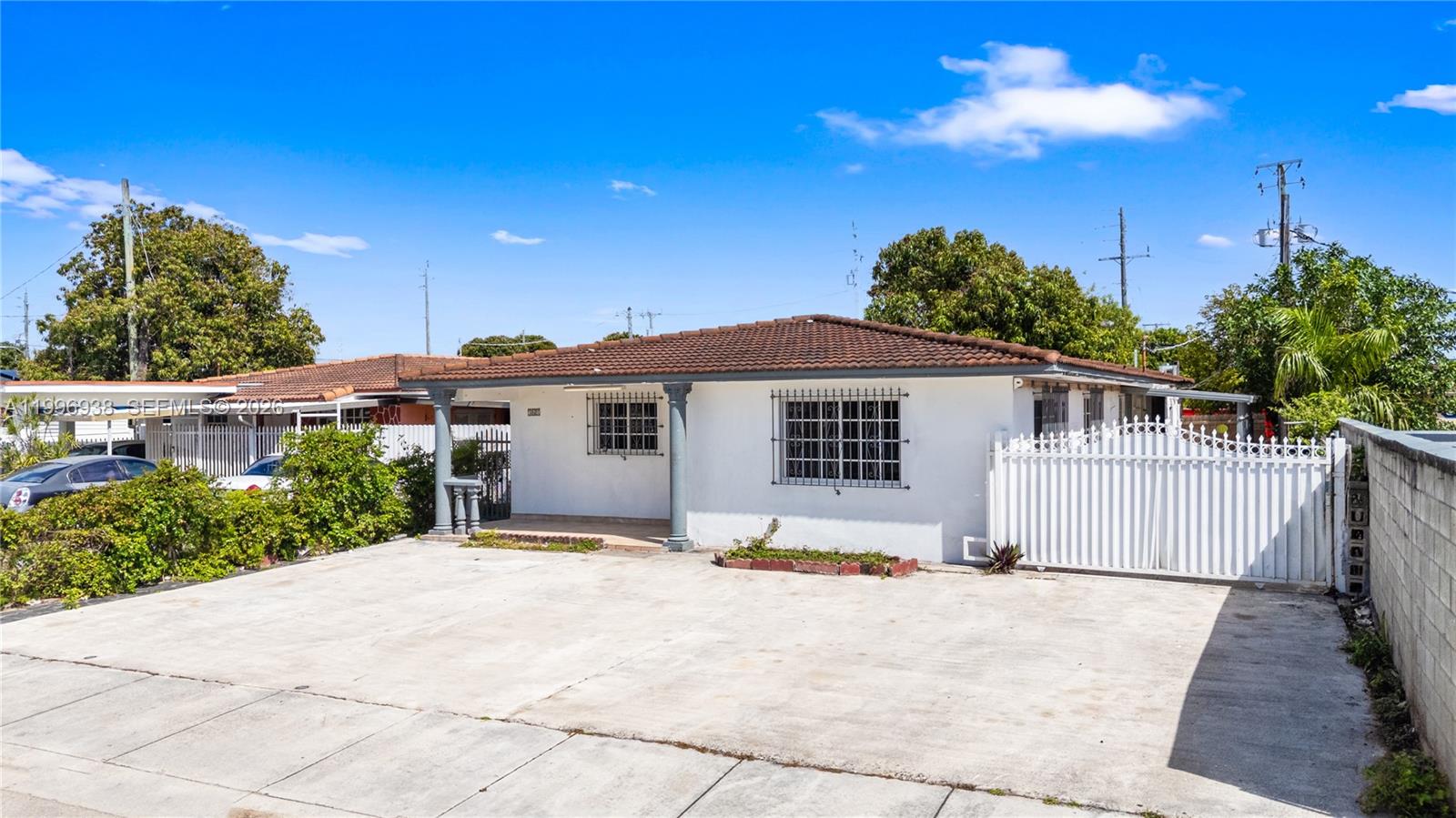 361 East 39th Street, Unit 1 Hialeah, FL 33013 - Photo 33 of 47 a front view of a house with a yard and potted plants
