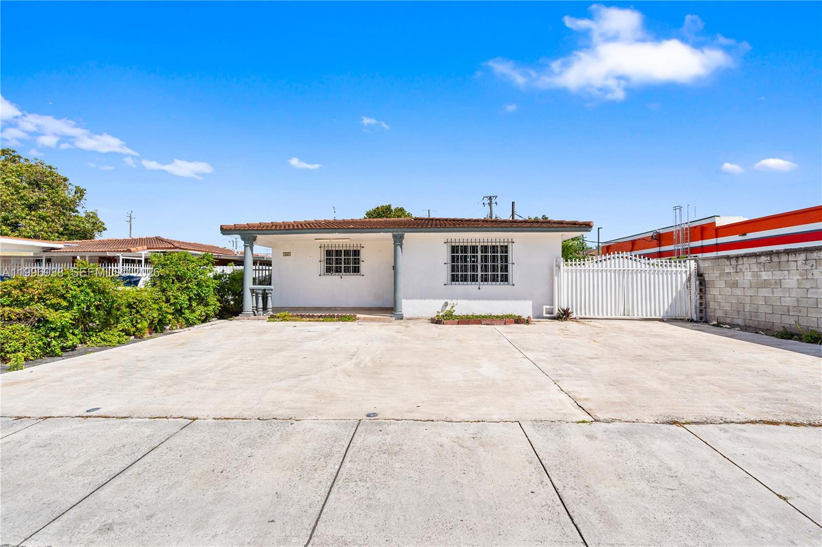 361 East 39th Street, Unit 1 Hialeah, FL 33013 - Photo 34 of 47 a view of a house with a backyard and a garage
