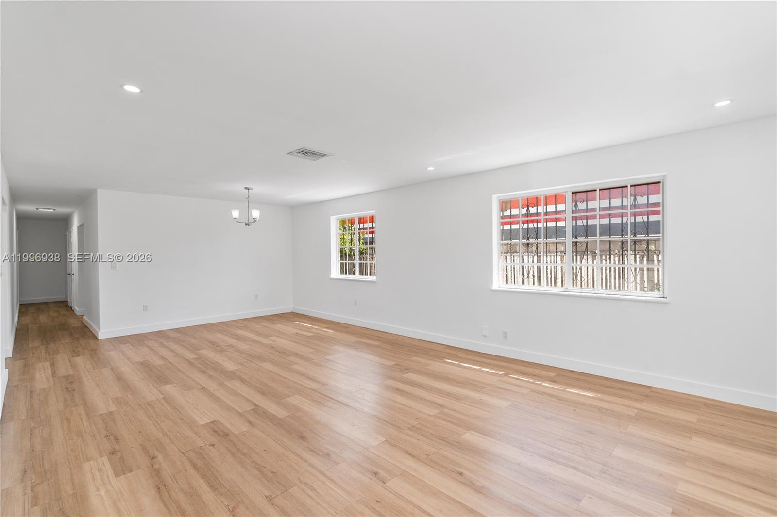 361 East 39th Street, Unit 1 Hialeah, FL 33013 - Photo 5 of 47 wooden floor in an empty room with a window