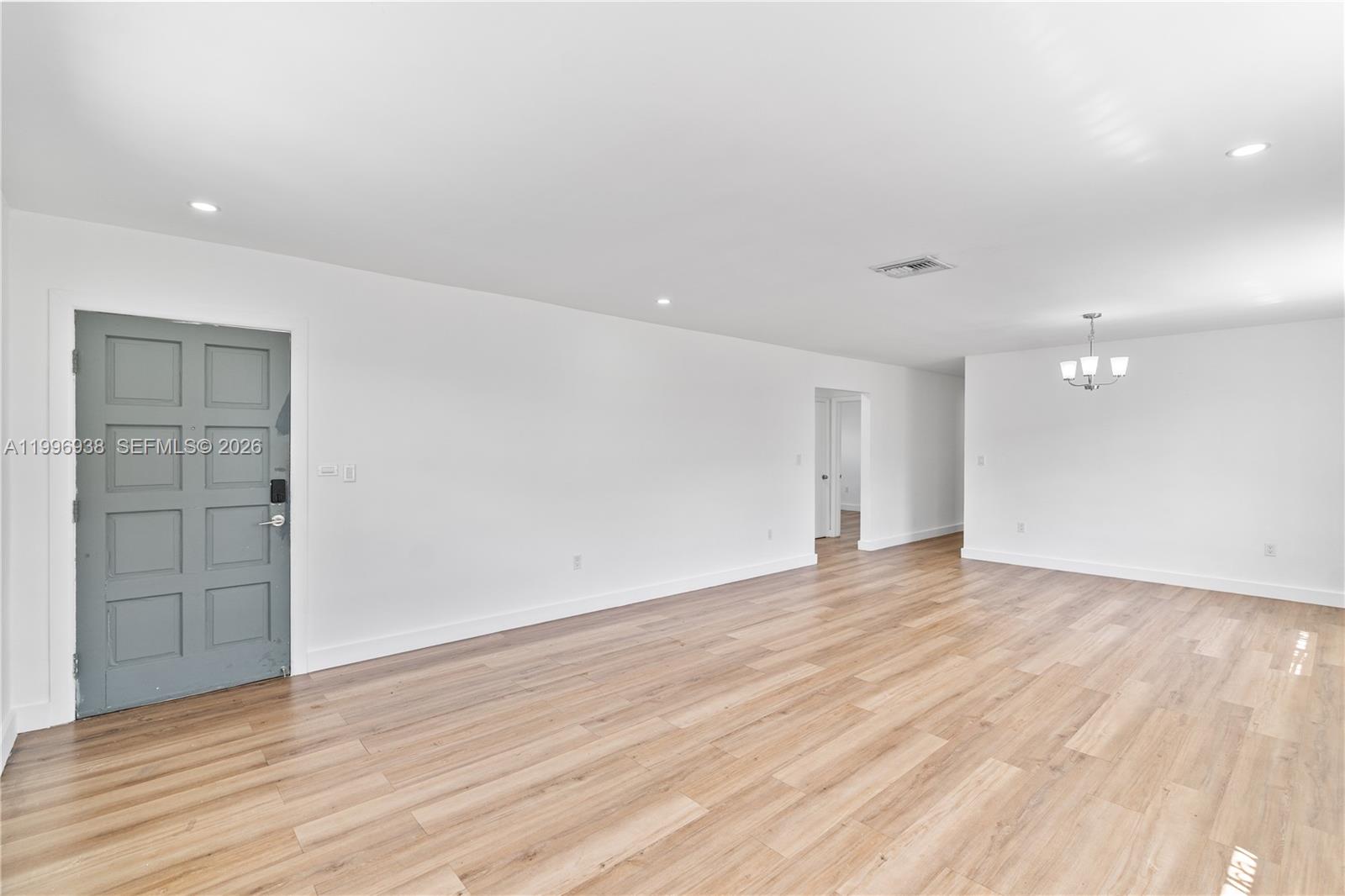 361 East 39th Street, Unit 1 Hialeah, FL 33013 - Photo 6 of 47 a view of an empty room with wooden floor and closet
