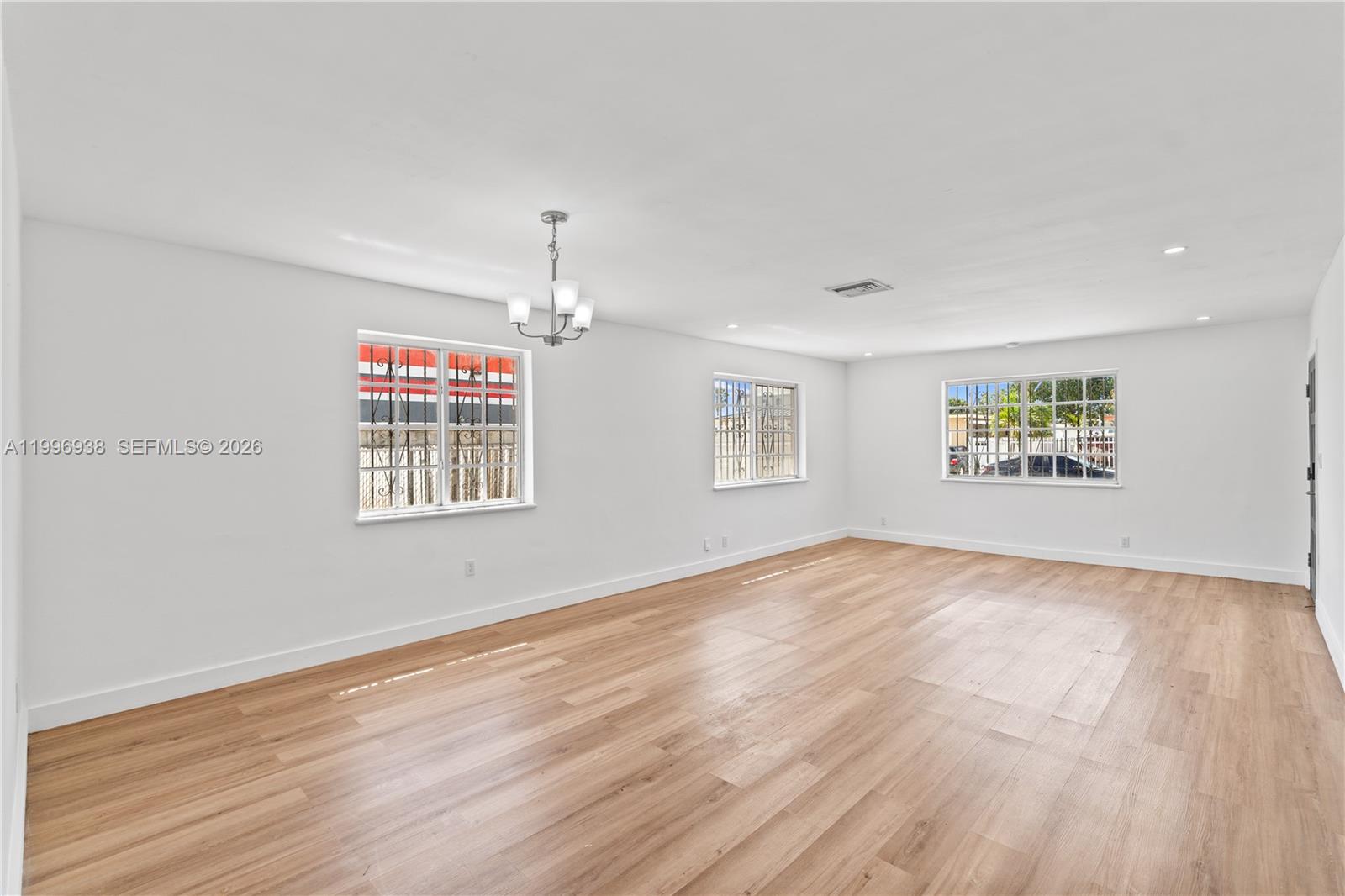 361 East 39th Street, Unit 1 Hialeah, FL 33013 - Photo 8 of 47 wooden floor in an empty room with a window