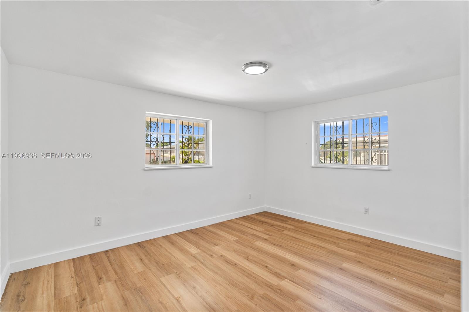 361 East 39th Street, Unit 1 Hialeah, FL 33013 - Photo 9 of 47 a view of a big room with wooden floor and a window