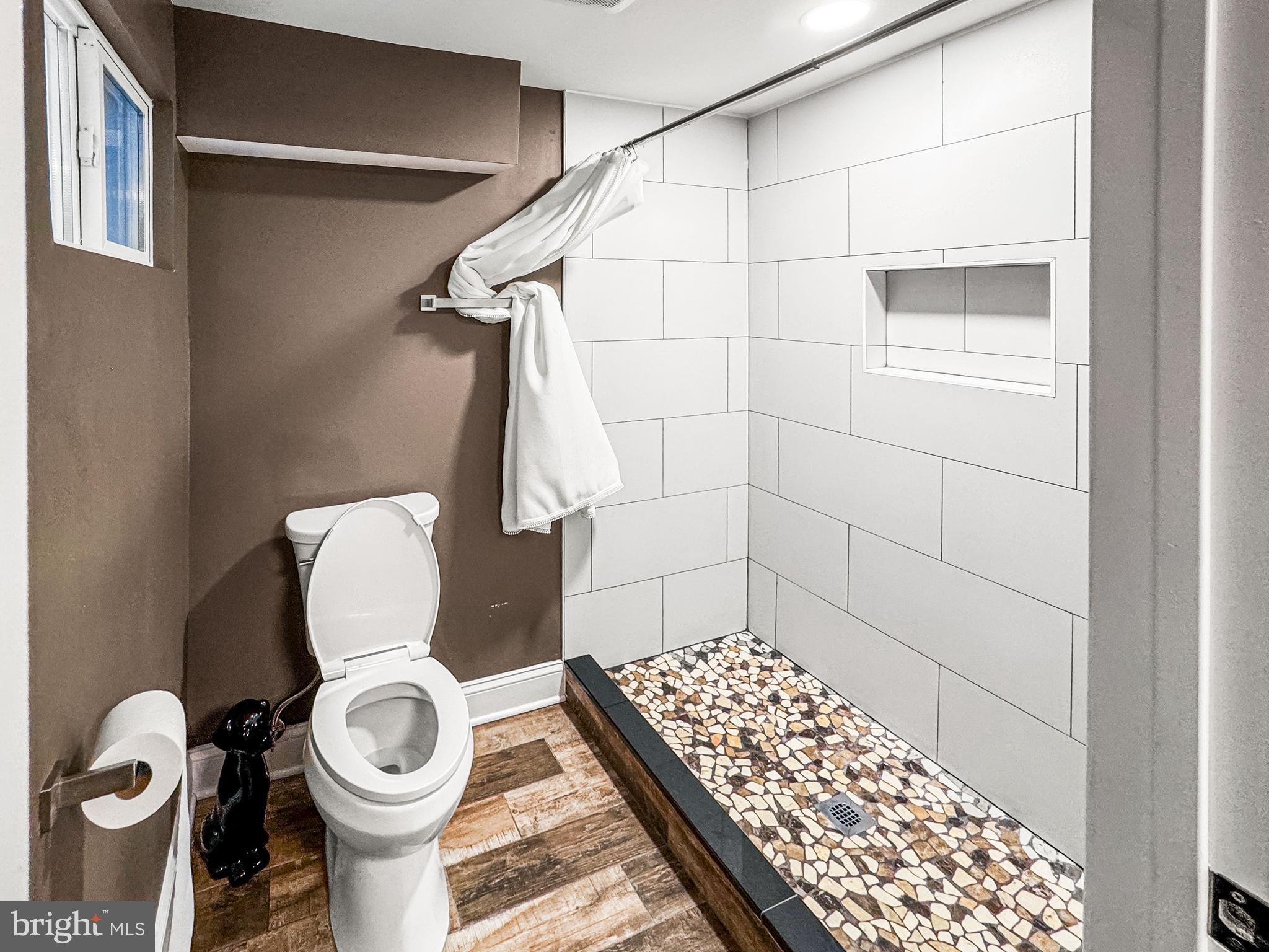 223 Main Street Hamilton, NJ 08620 - Photo 15 of 22 a bathroom with a toilet and a shower