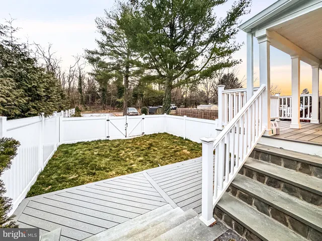 a view of a pathway with a wrought fence