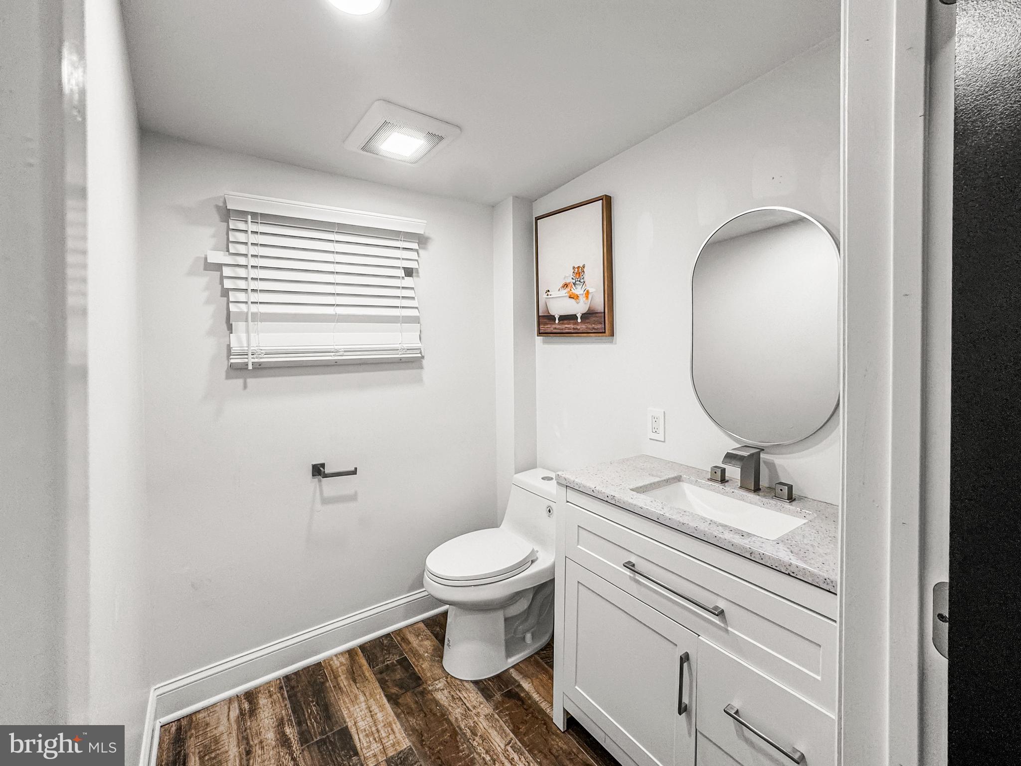 223 Main Street Hamilton, NJ 08620 - Photo 7 of 22 a bathroom with a toilet a sink and mirror