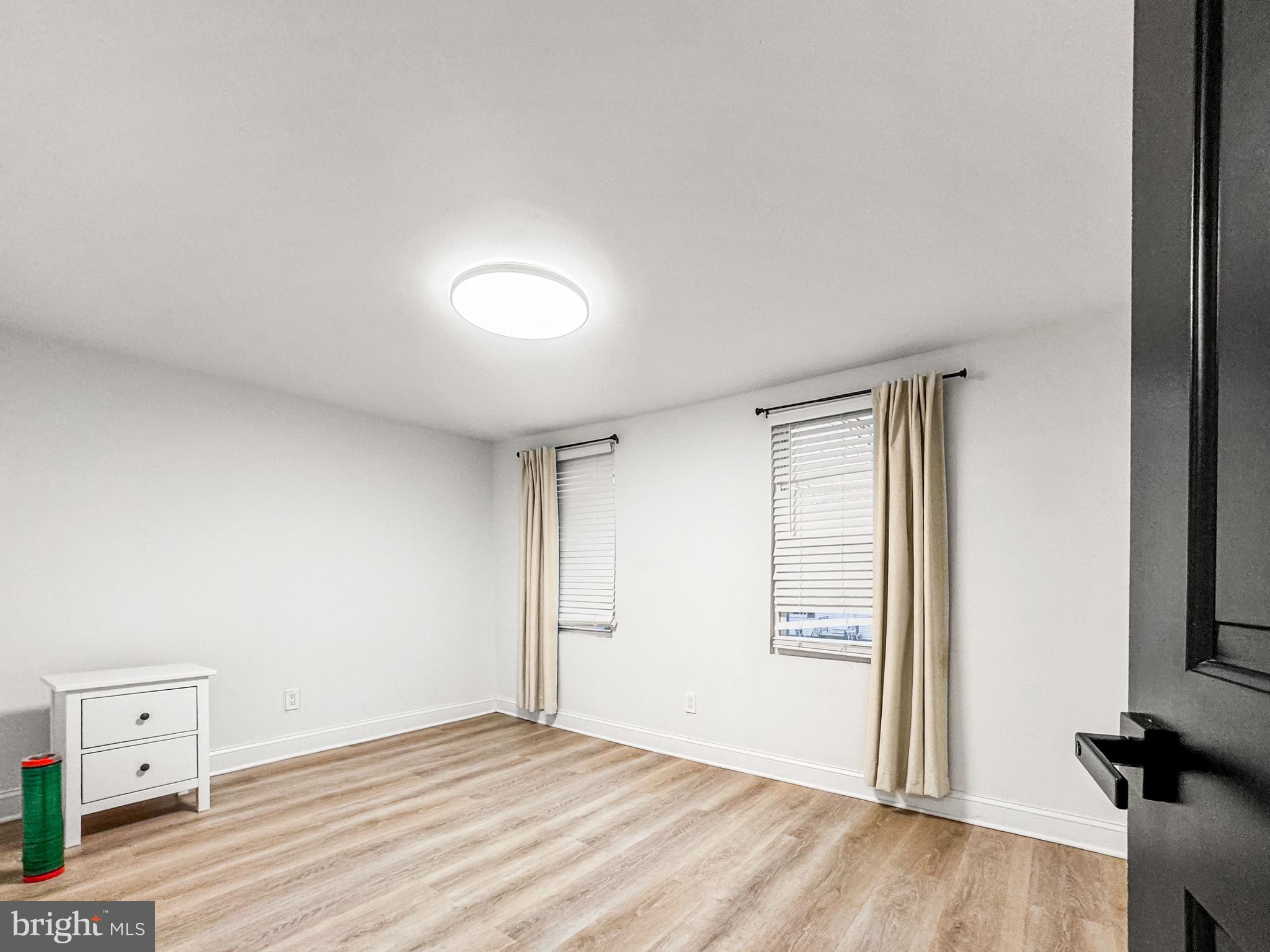 223 Main Street Hamilton, NJ 08620 - Photo 9 of 22 an empty room with wooden floor and windows