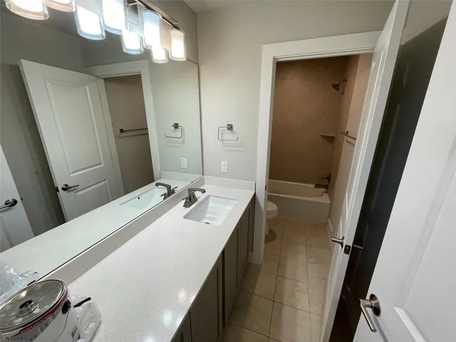 a en suite bathroom with a double vanity sink a mirror and a shower