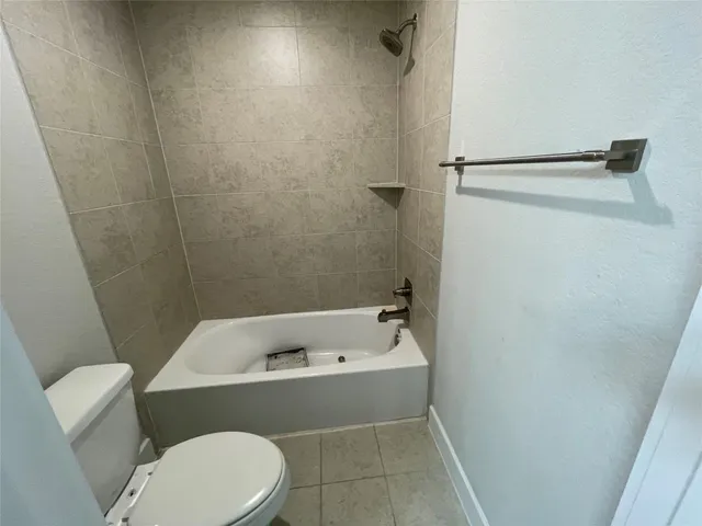 a bathroom with a bathtub and toilet