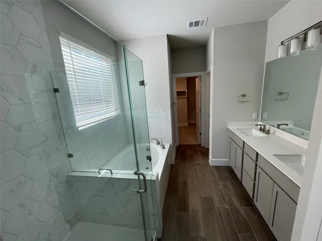 a bathroom with a double vanity sink and mirror