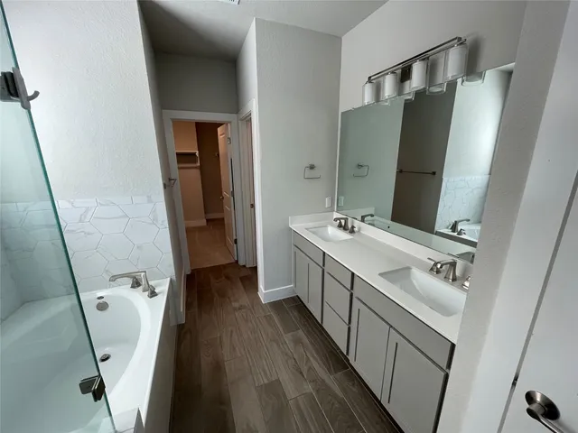a bathroom with a double vanity sink and mirror