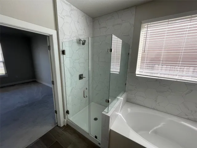 a bathroom with a bathtub and a shower