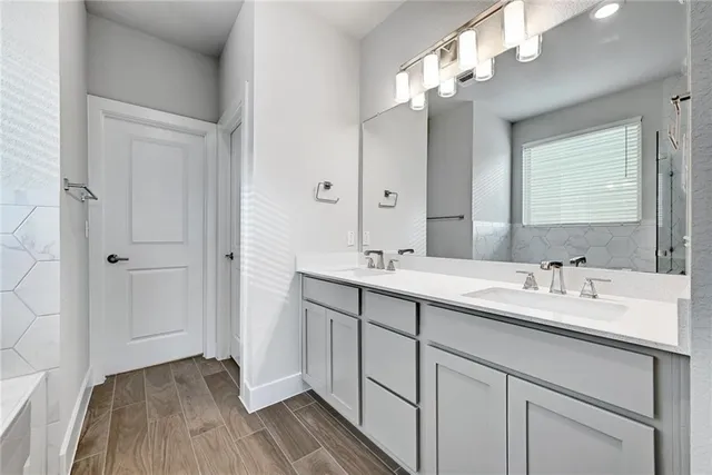 a bathroom with a double vanity sink and a mirror