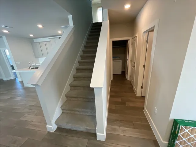 a view of staircase with white walls and a window