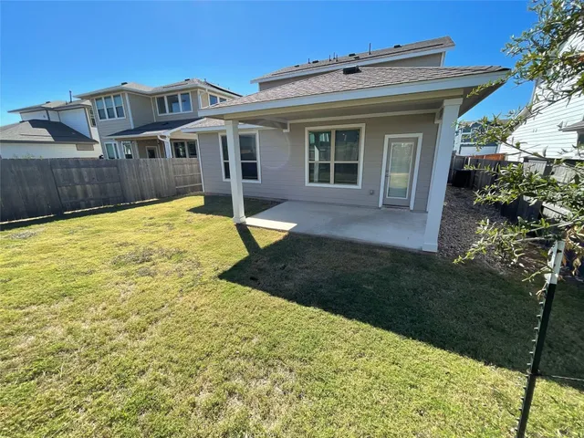 a view of a house with backyard and sitting area