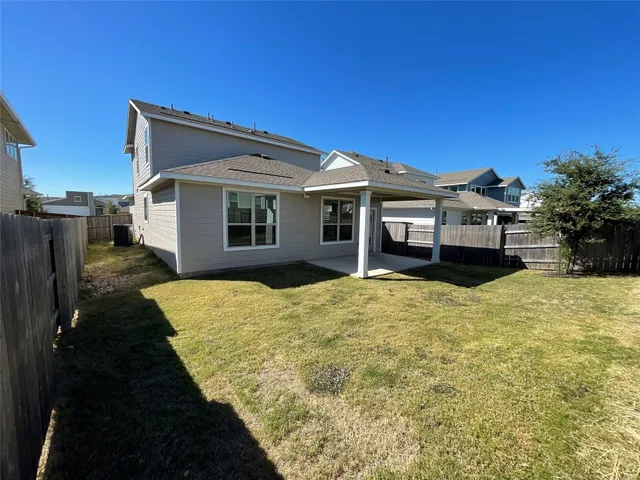 a view of a house with a backyard