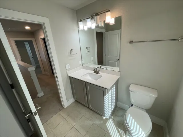 a bathroom with a sink vanity and toilet