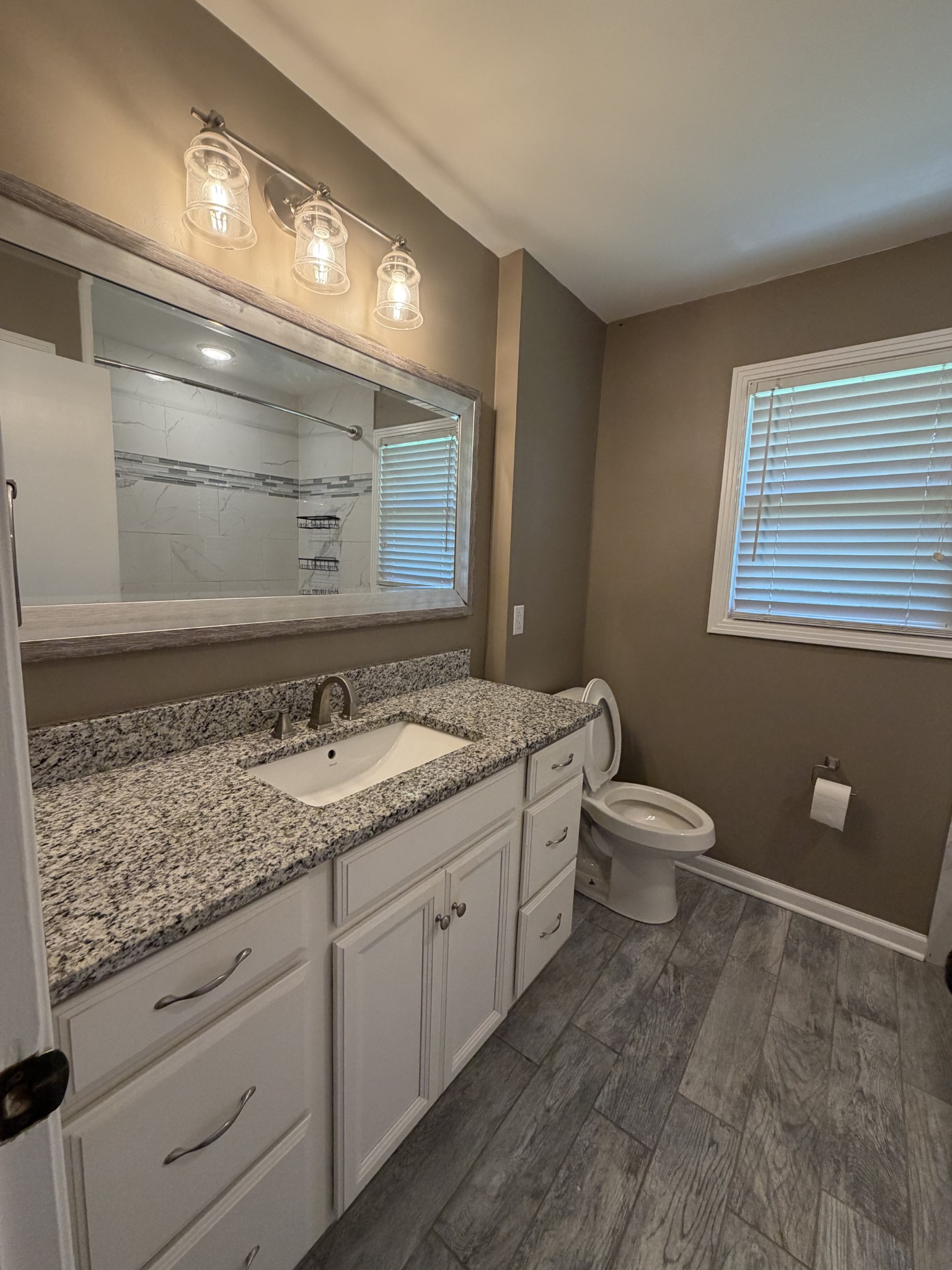 2280 Graham Cemetery Road Clarksville, TN 37043 - Photo 12 of 19 a bathroom with a granite countertop sink and a toilet