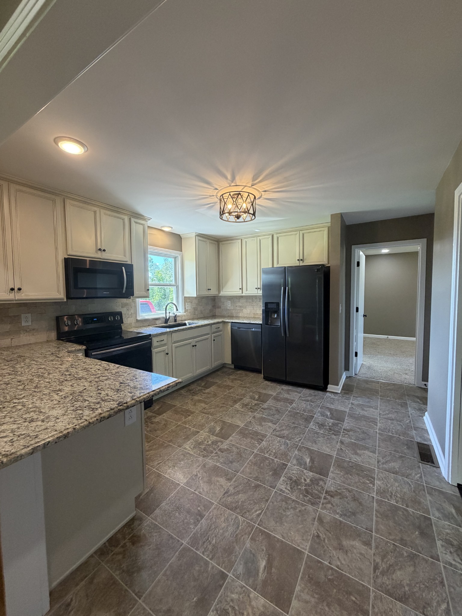 2280 Graham Cemetery Road Clarksville, TN 37043 - Photo 7 of 19 a kitchen with stainless steel appliances granite countertop a refrigerator and a stove top oven
