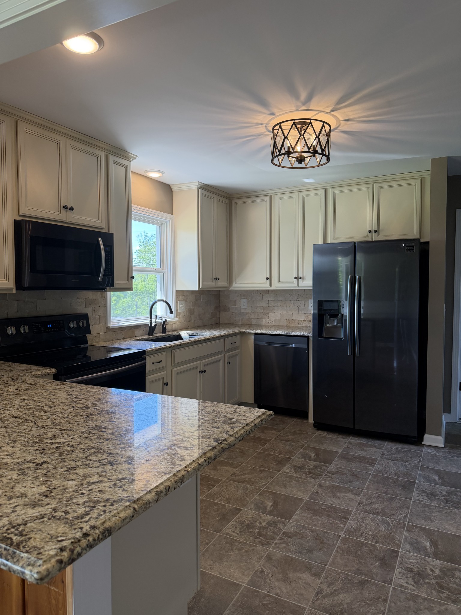 2280 Graham Cemetery Road Clarksville, TN 37043 - Photo 8 of 19 a kitchen with stainless steel appliances granite countertop a refrigerator a stove a sink and a granite counter tops