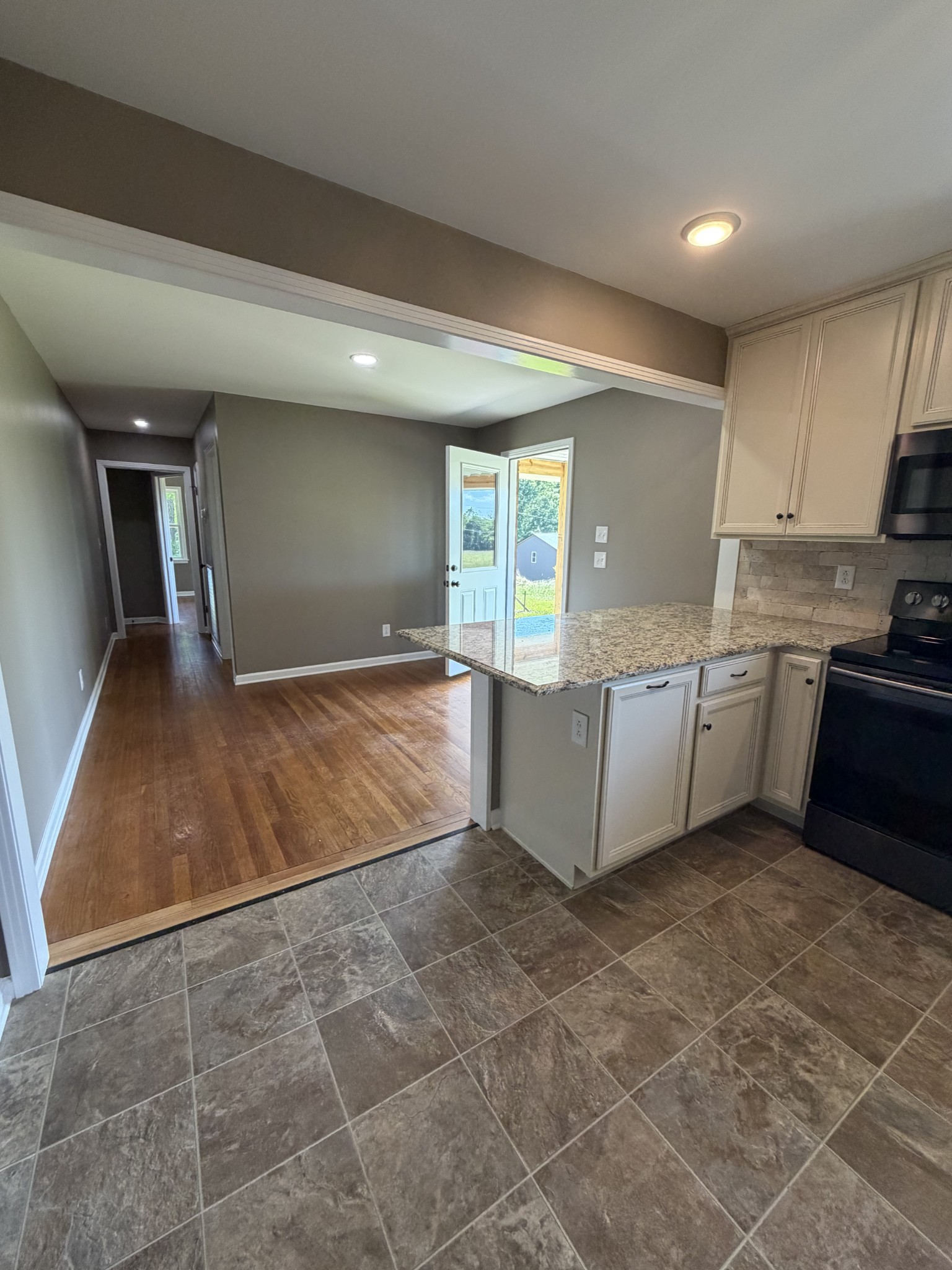 2280 Graham Cemetery Road Clarksville, TN 37043 - Photo 9 of 19 a view of a kitchen with kitchen island a sink wooden floor and counter top space