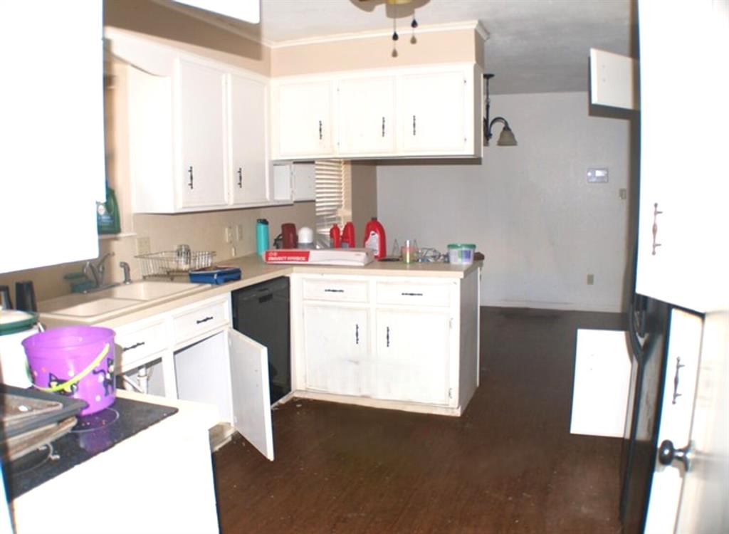 511 California Street Clyde, TX 79510 - Photo 5 of 13 a kitchen with a sink dishwasher and a stove with wooden floor