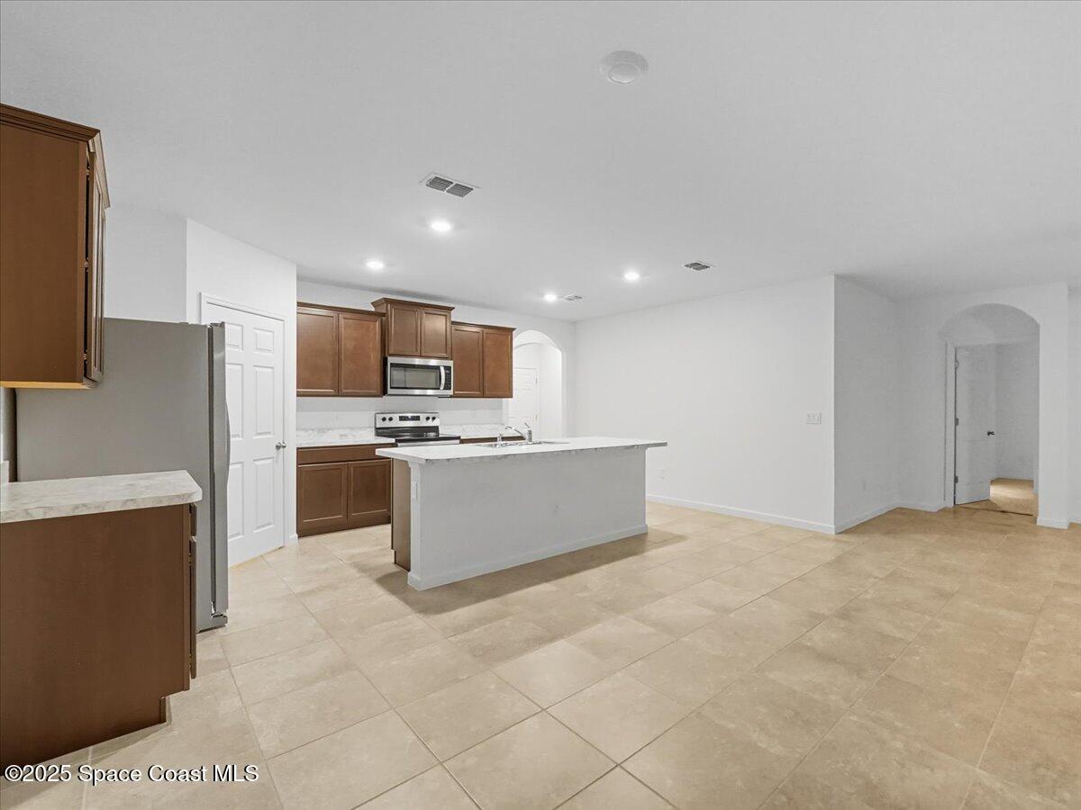 352 Catfish Place Cocoa, FL 32927 - Photo 11 of 30 a large kitchen with cabinets and stainless steel appliances