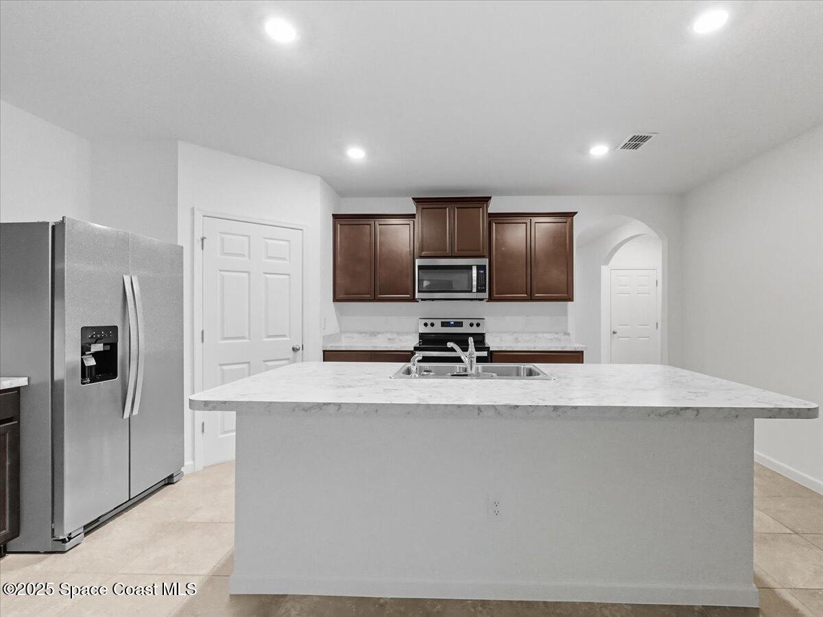 352 Catfish Place Cocoa, FL 32927 - Photo 15 of 30 a view of kitchen with stainless steel appliances granite countertop refrigerator sink and stove