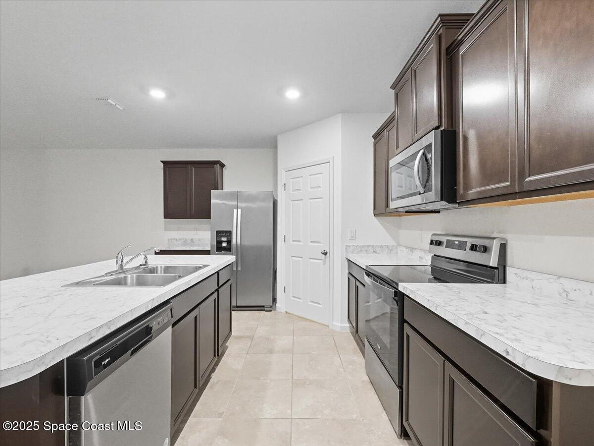352 Catfish Place Cocoa, FL 32927 - Photo 17 of 30 a kitchen with granite countertop stainless steel appliances and sink
