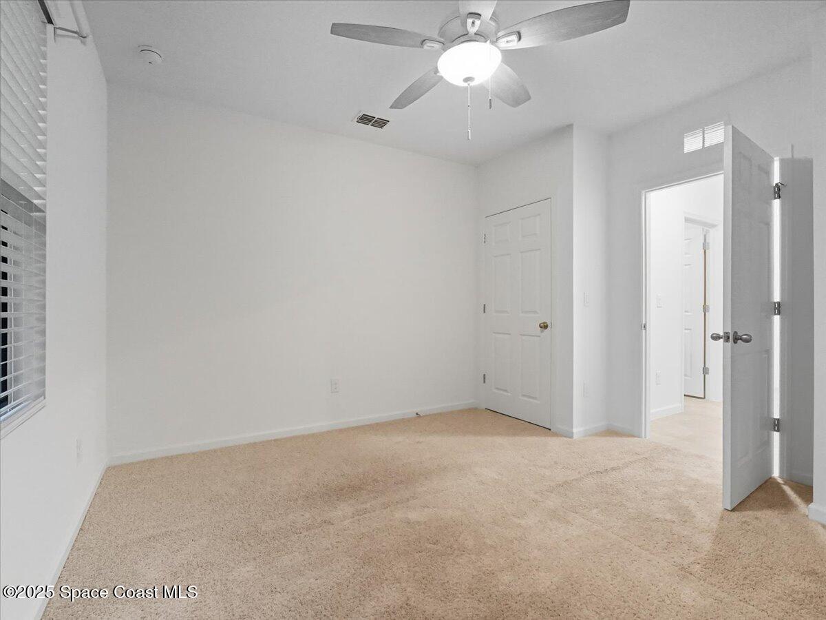 352 Catfish Place Cocoa, FL 32927 - Photo 19 of 30 an empty room with a chandelier fan and closet area