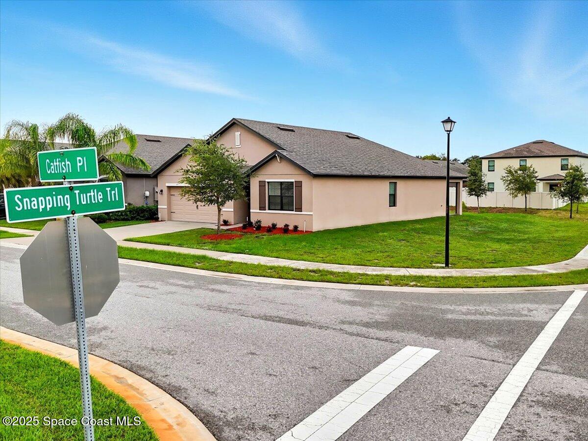 352 Catfish Place Cocoa, FL 32927 - Photo 3 of 30 a view of a house with a yard and sitting area