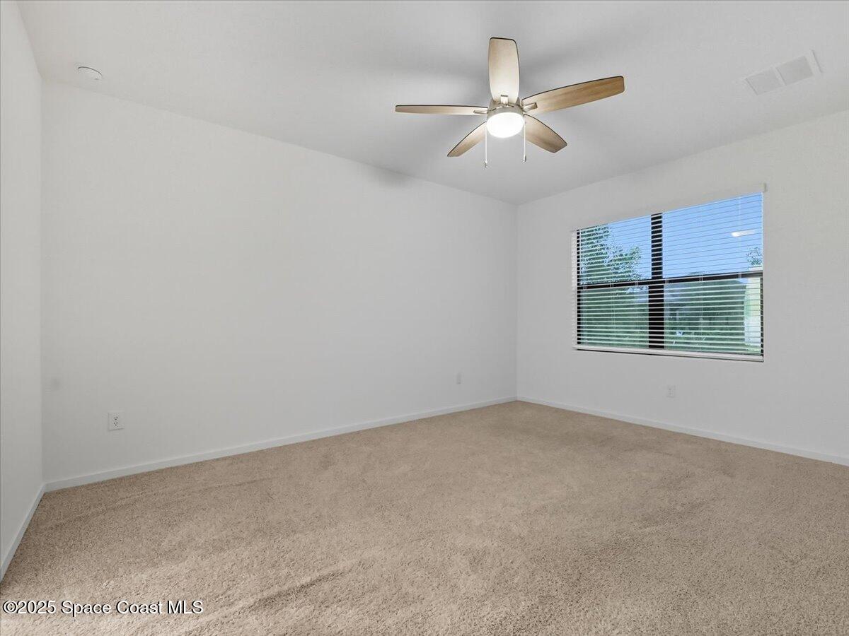 352 Catfish Place Cocoa, FL 32927 - Photo 9 of 30 an empty room with a ceiling fan and window