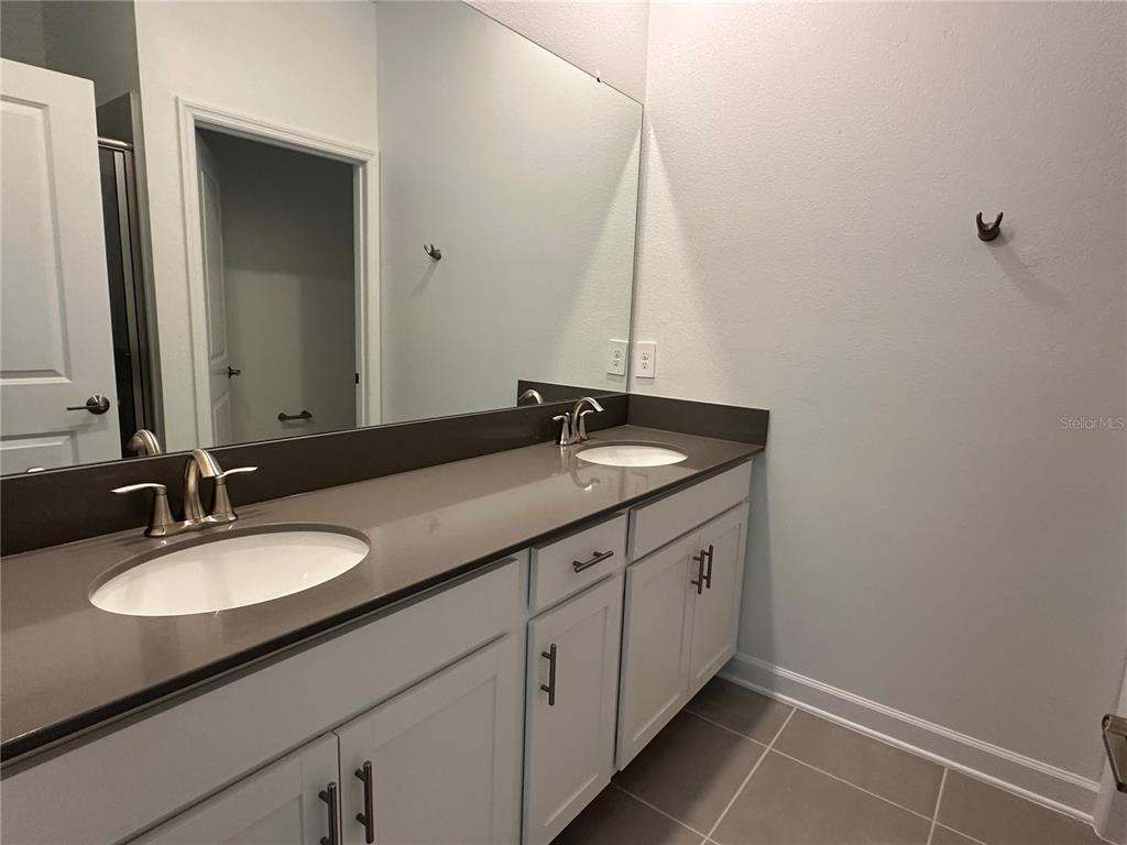 3128 Addison Boulevard St. Cloud, FL 34771 - Photo 15 of 35 a bathroom with a granite countertop sink and a mirror