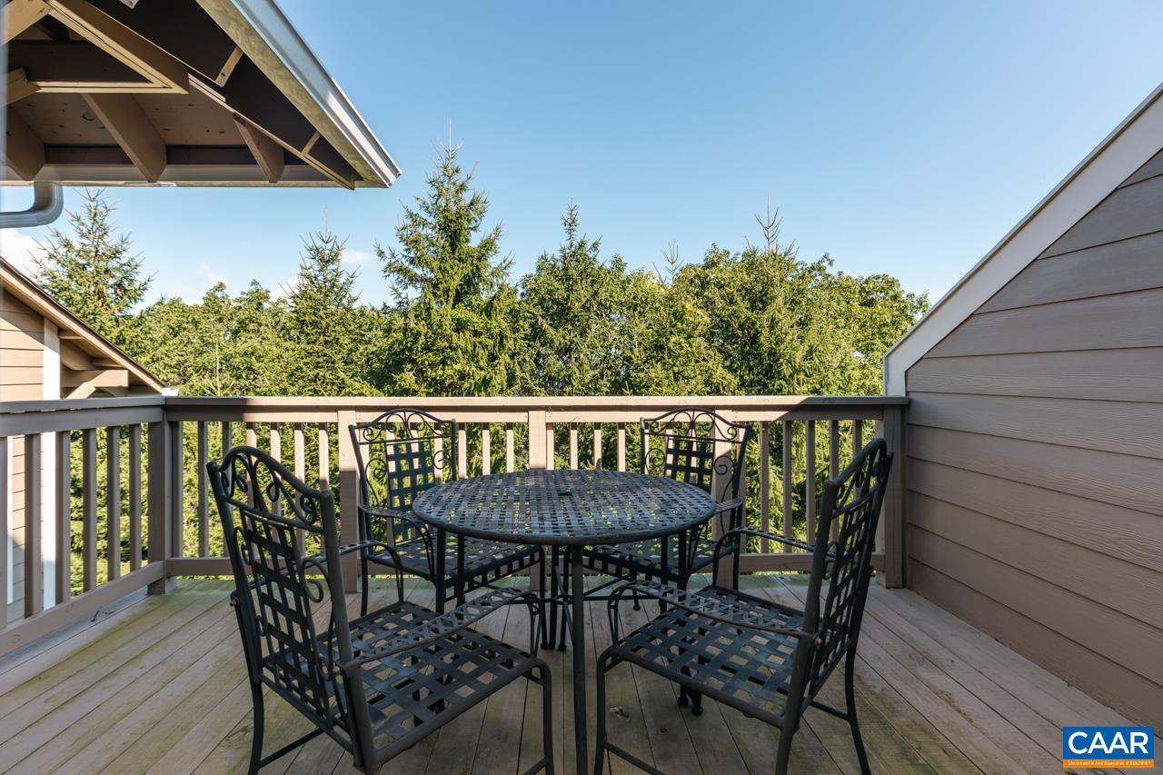 2078 Stone Ridge Roseland, VA 22967 - Photo 2 of 39 a balcony with wooden floor table and chairs