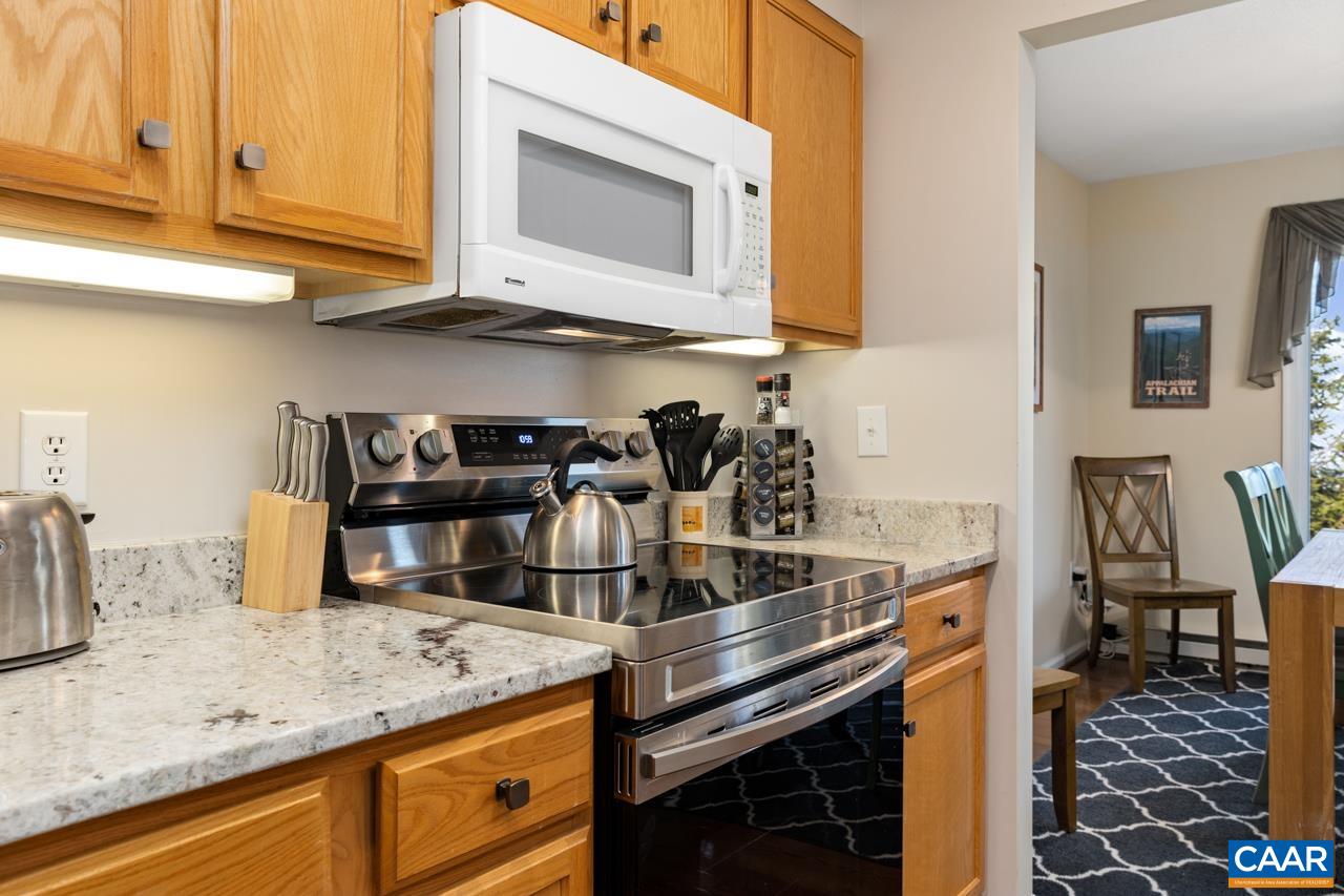 2078 Stone Ridge Roseland, VA 22967 - Photo 6 of 39 a kitchen with stainless steel appliances granite countertop a stove and a microwave