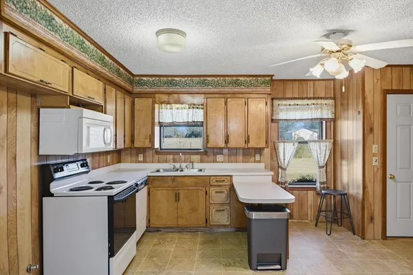 a kitchen with a sink stove and cabinets