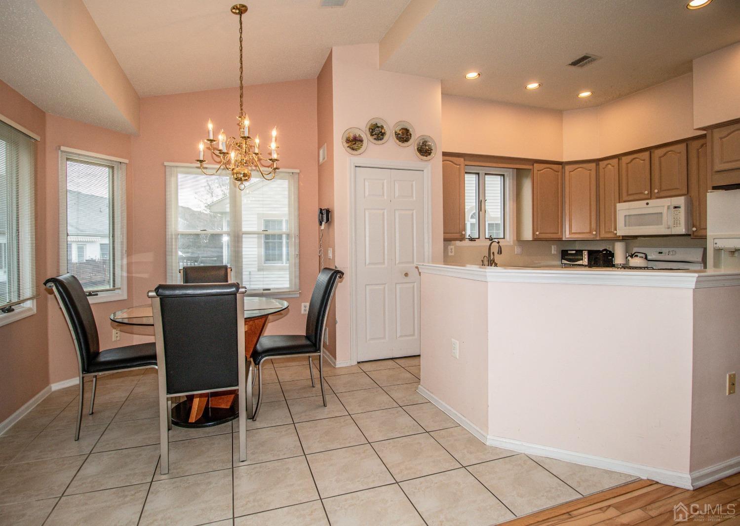 32 Harwood Road Monroe Township, NJ 08831 - Photo 11 of 34 a dining room with furniture a window and kitchen view