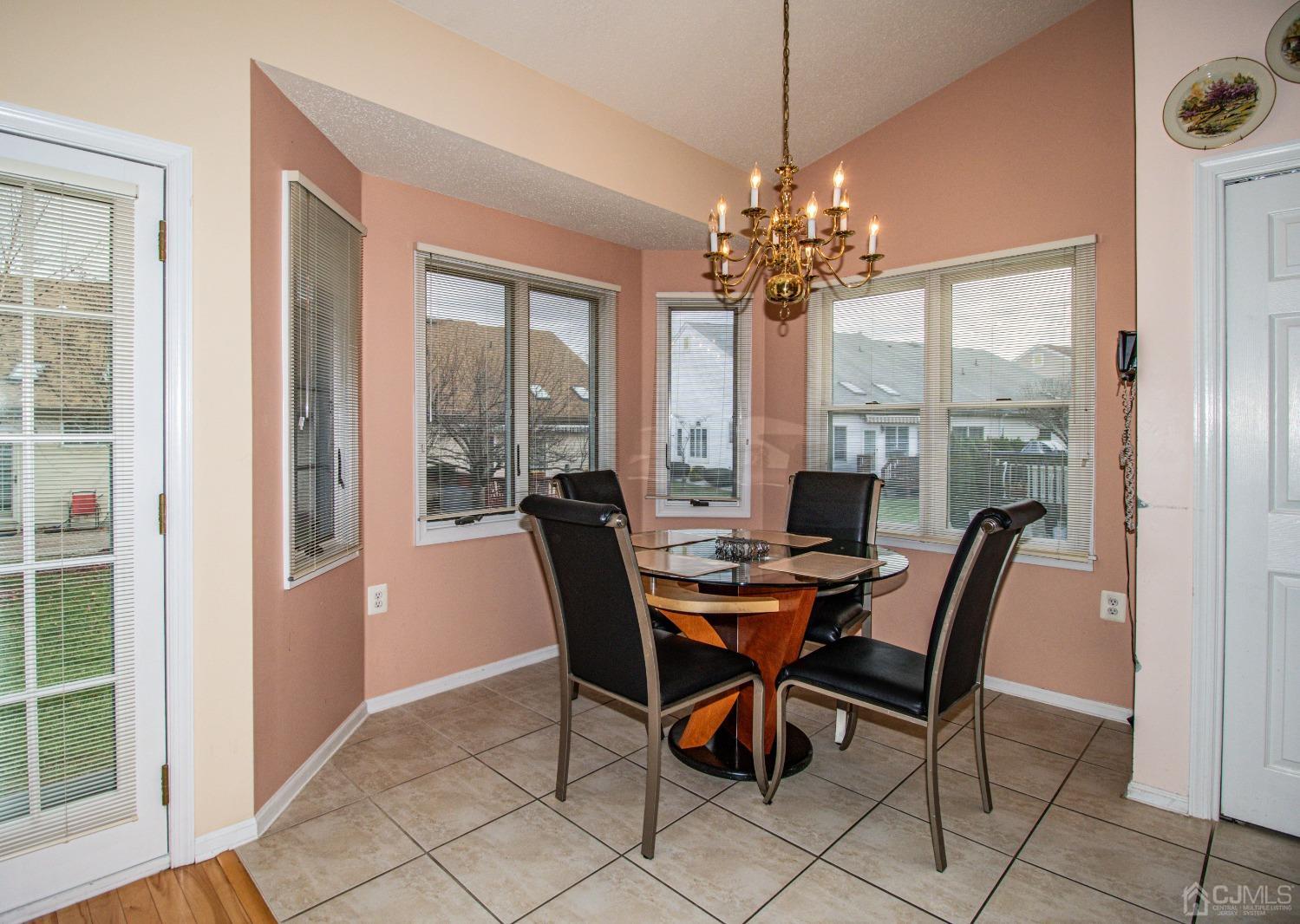 32 Harwood Road Monroe Township, NJ 08831 - Photo 13 of 34 a view of a dining room with furniture large windows and wooden floor