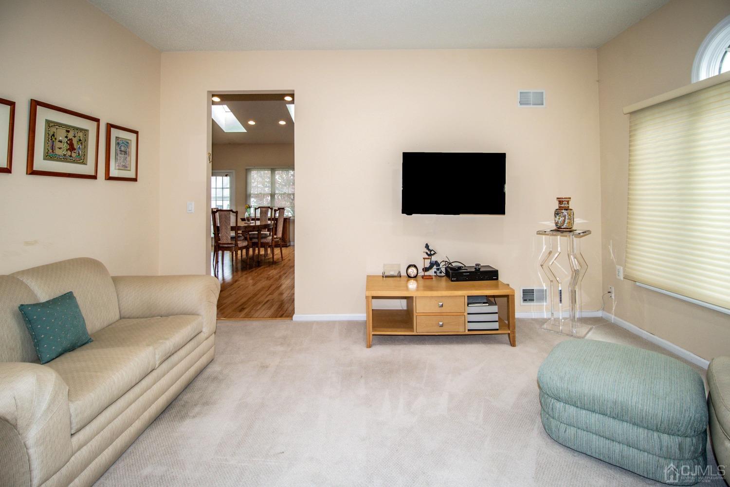 32 Harwood Road Monroe Township, NJ 08831 - Photo 20 of 34 a living room with furniture and a flat screen tv