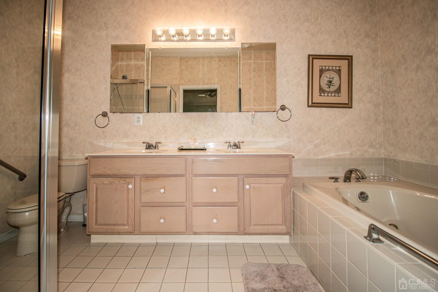 32 Harwood Road Monroe Township, NJ 08831 - Photo 27 of 34 a bathroom with a sink a vanity and a mirror