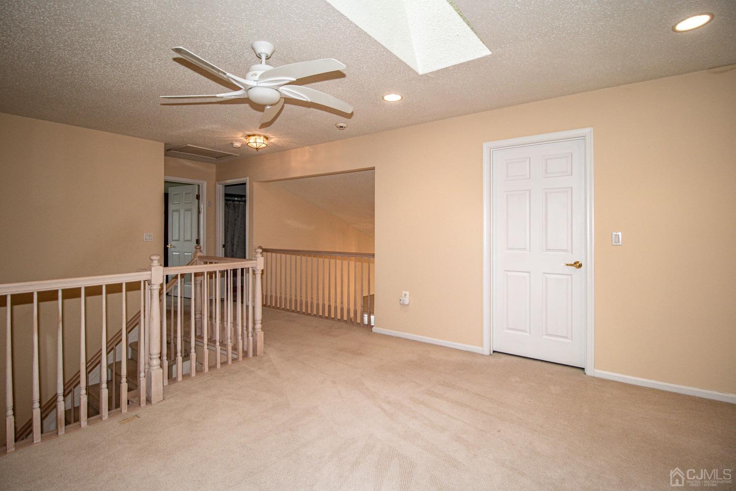 32 Harwood Road Monroe Township, NJ 08831 - Photo 29 of 34 an empty room with ceiling fan and windows
