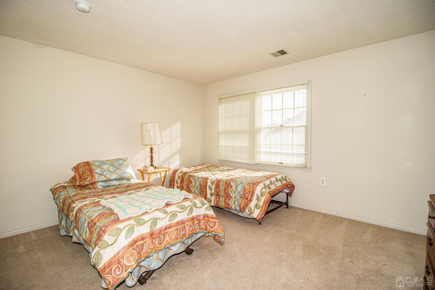 32 Harwood Road Monroe Township, NJ 08831 - Photo 31 of 34 a bedroom with two beds and a window