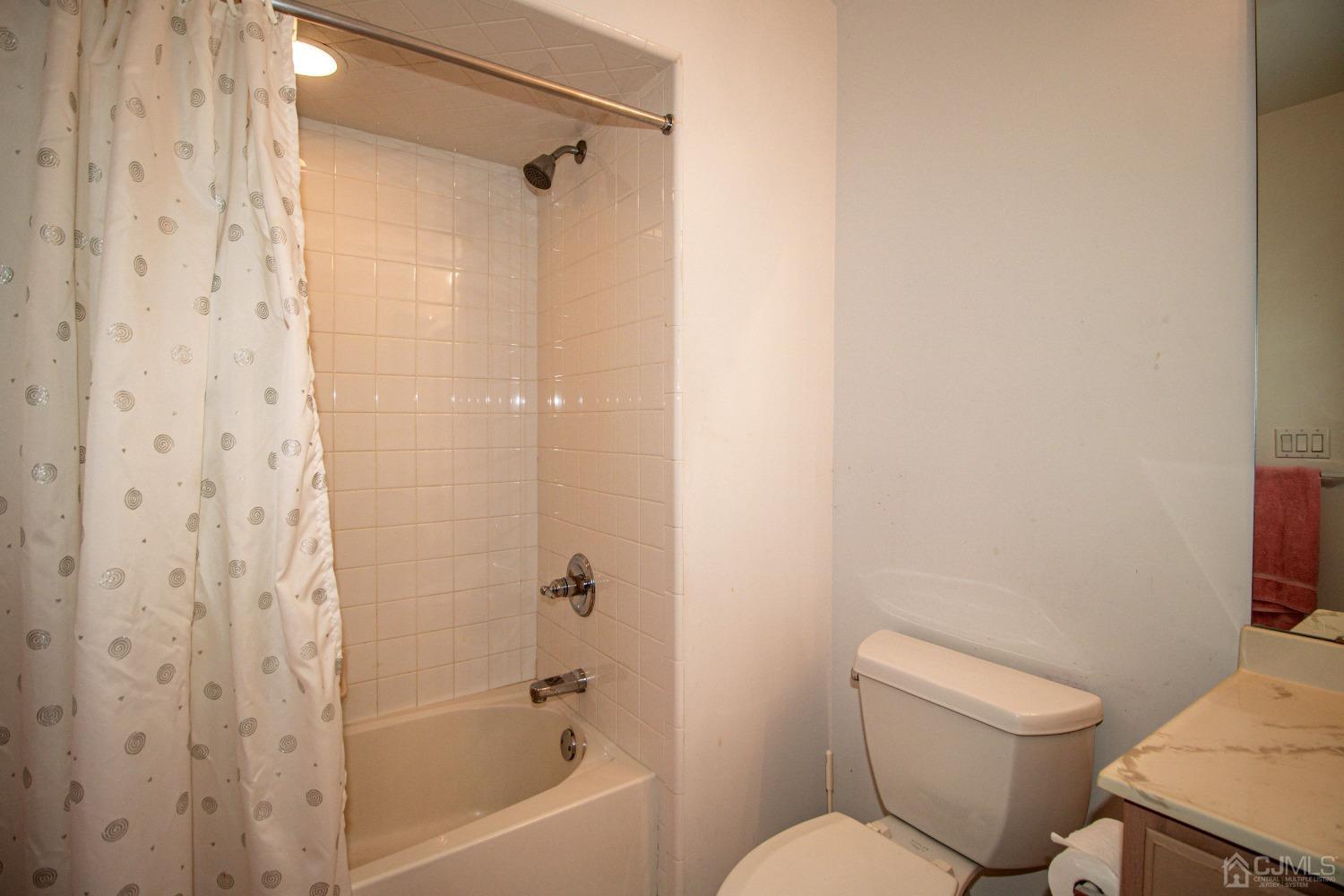 32 Harwood Road Monroe Township, NJ 08831 - Photo 32 of 34 a white toilet sitting next to a bath tub