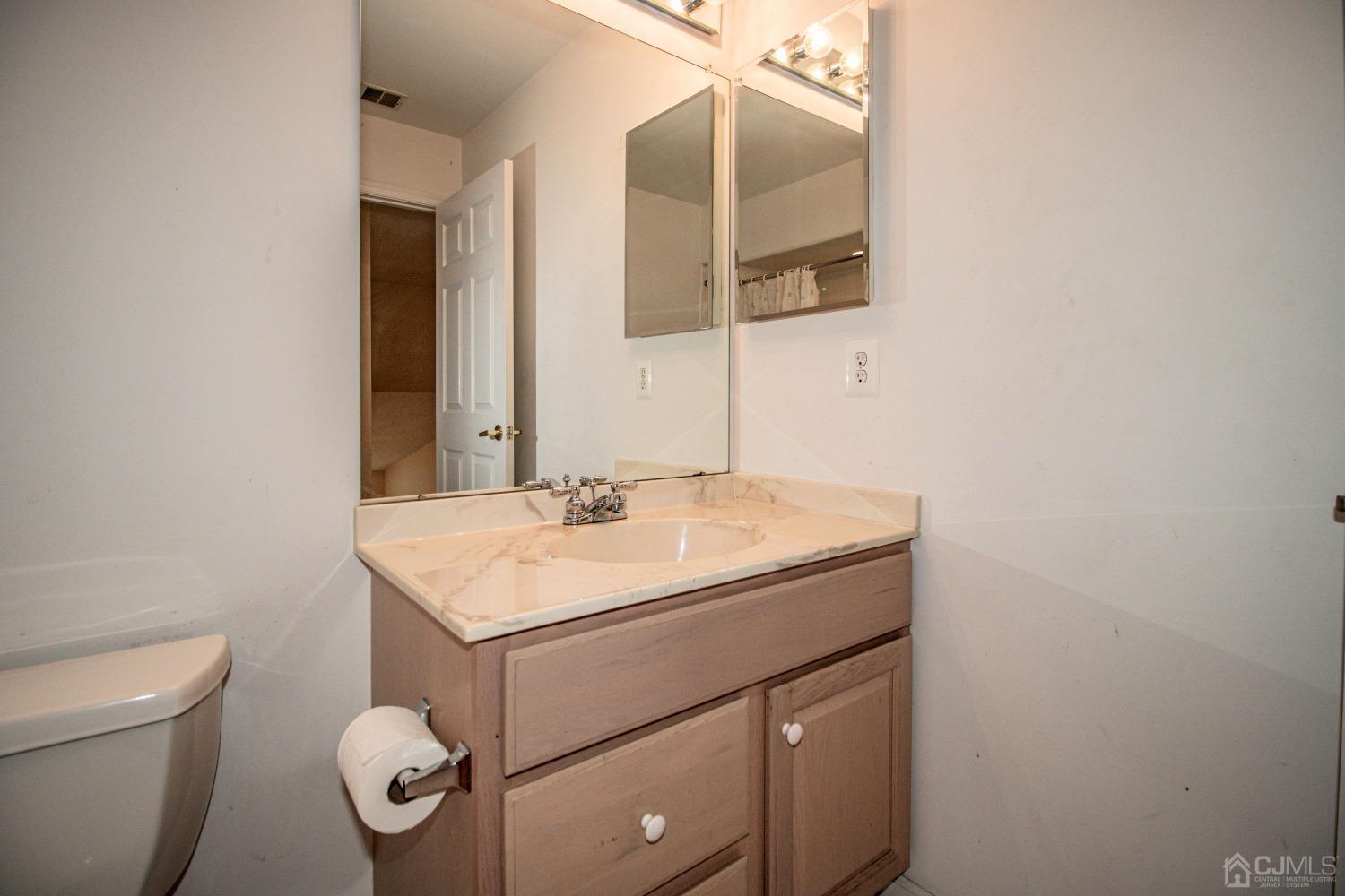 32 Harwood Road Monroe Township, NJ 08831 - Photo 33 of 34 a bathroom with a sink toilet and mirror