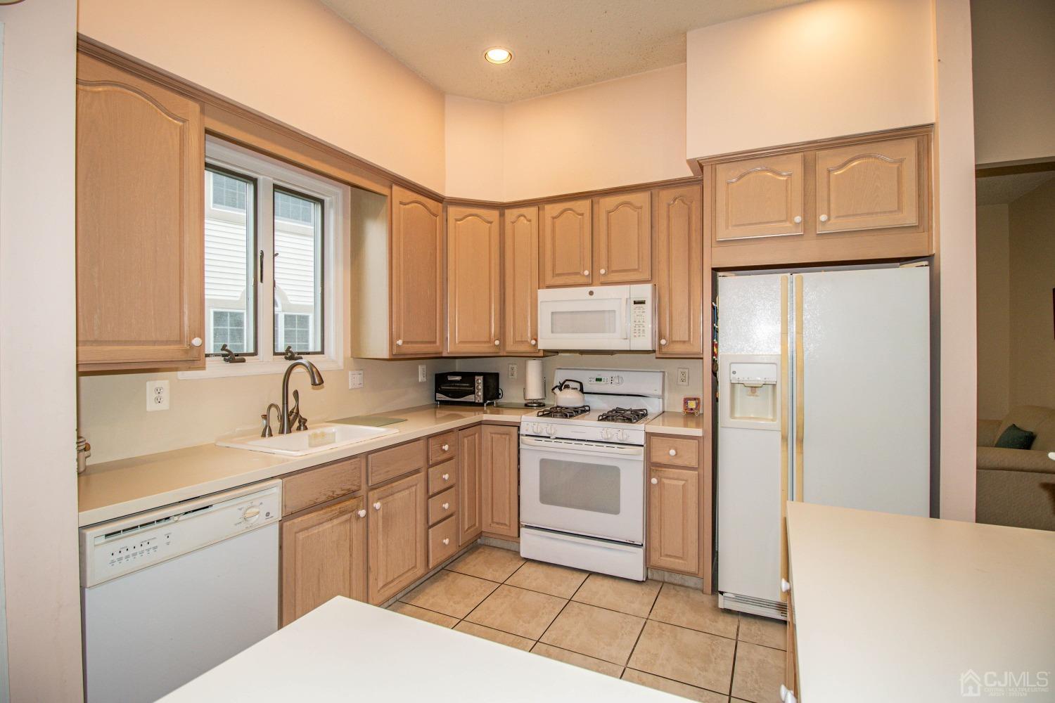 32 Harwood Road Monroe Township, NJ 08831 - Photo 10 of 34 a kitchen with a sink stove and refrigerator