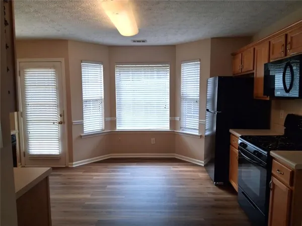an empty room with wooden floor and a window